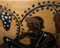 Man and vines on a black figure ware vessel