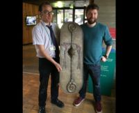 Tom Hughes presenting the shield to The Collection's Dr Erik Grigg